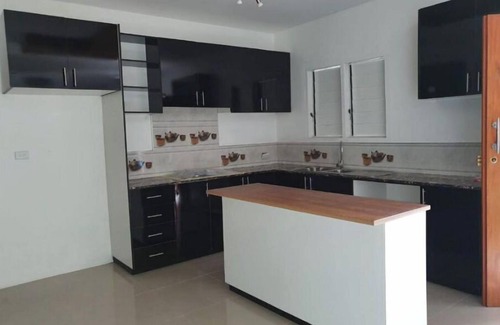 Suva Apartment | Master Bedroom with shared kitchen and living room