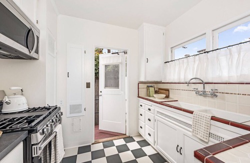 West Beach Apartment | Enjoy indoor-outdoor living, a full kitchen, and vintage coastal charm.