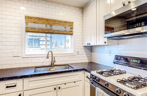 Corridor Apartment | Inviting apartment with grill, balcony, full kitchen, & W/D
