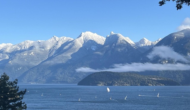 A cozy guest suite with a panoramic ocean view facing the Howe Sound Mountain