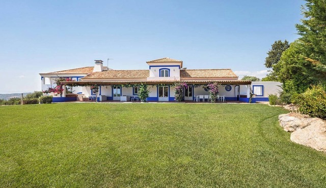 A happy family home boasting lovely gardens and 2 swimming pools