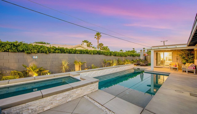 Designer dream with fireplace, game room, private pool, outdoor kitchen, firepit